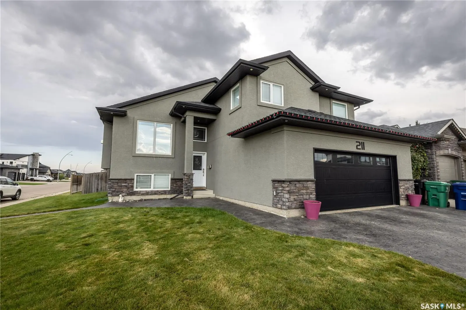 Exterior photo of 211 Sauer Crescent, Saskatoon – beautiful family home on a corner lot with attached heated garage.